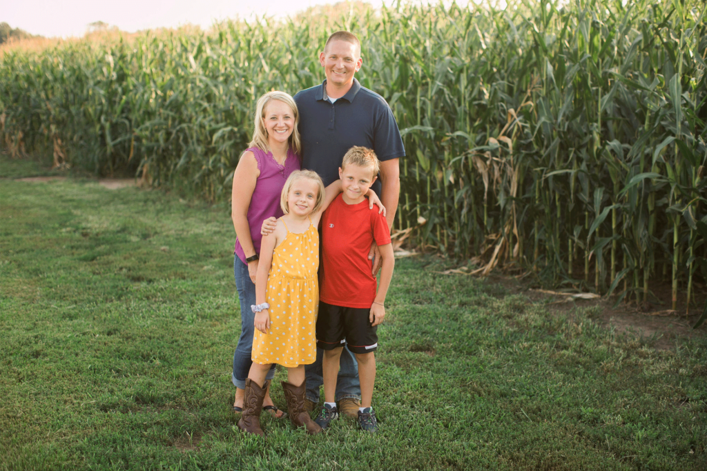 Gehrke family standing near corn field