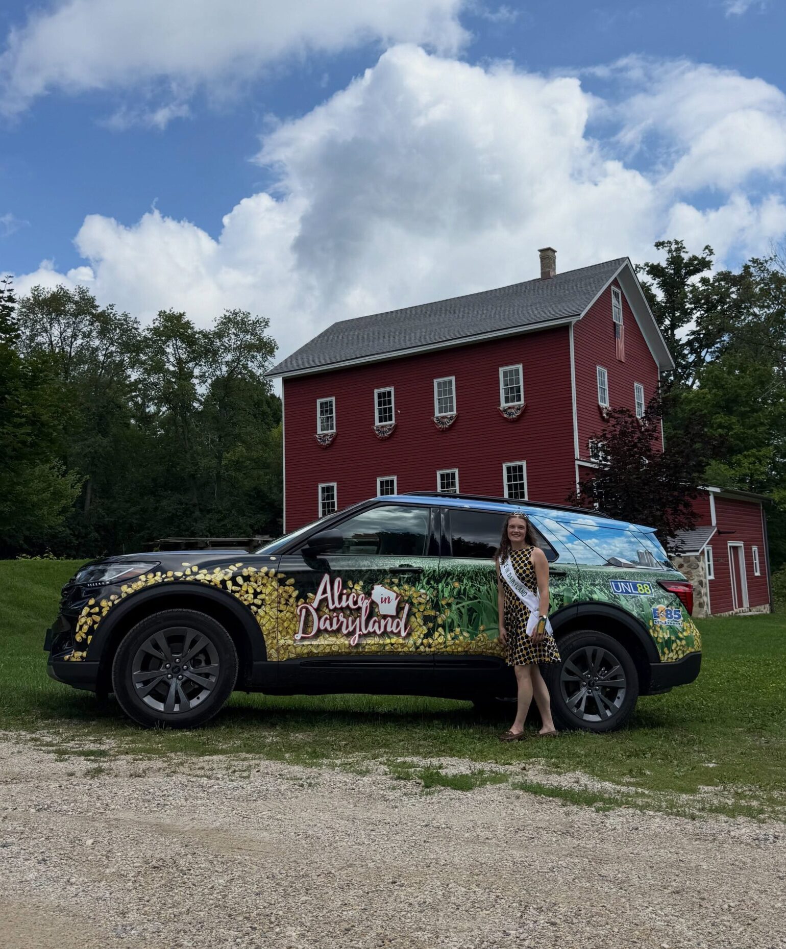 Photo of two women standing in front of the Alice in Dairyland car, holding car keys